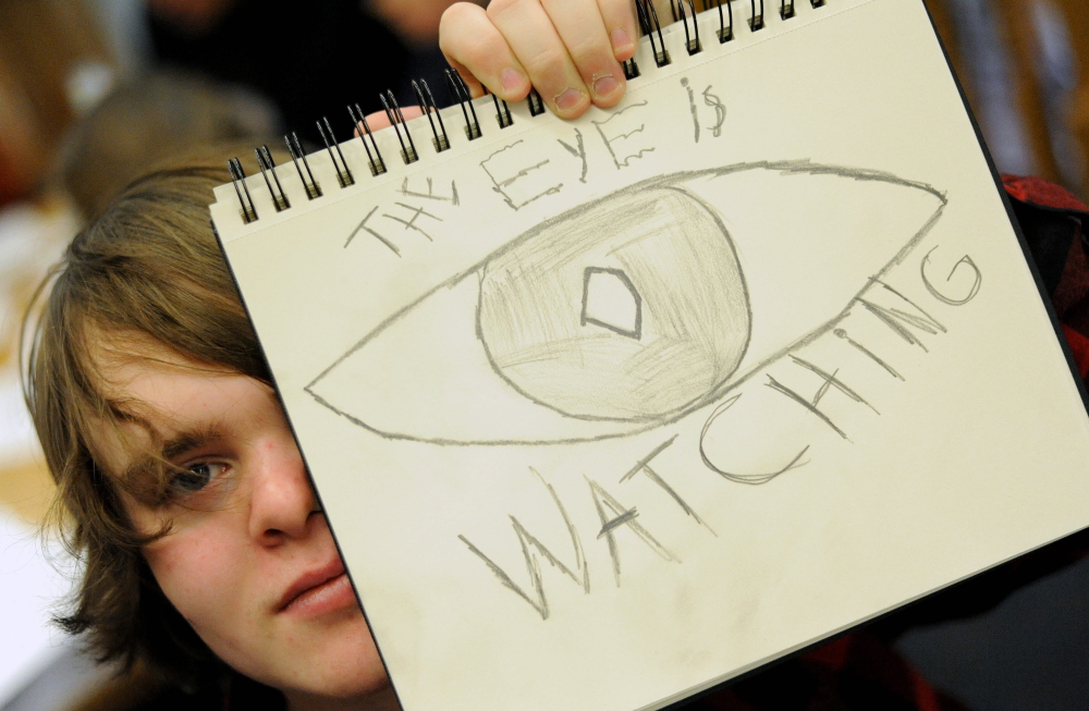 Noah Widen, 15, of Wilton, shows off his comic book creation during a comic book workshop organized by Mt. Blue English teacher Dan Ryden at the Wilton Free Public Library on Saturday.