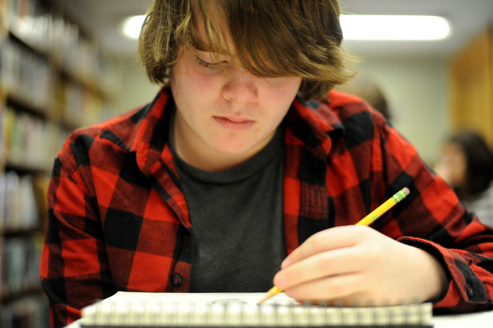 Noah Widen, 15, of Wilton, creates a comic character on his sketch pad during a comic book workshop organized by Mt. Blue English teacher Dan Ryden at the Wilton Free Public Library on Saturday.