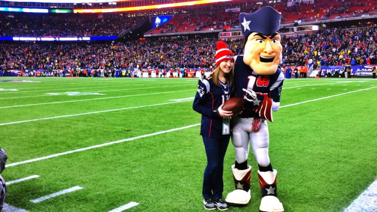Bethany Hammond, of Belgrade, poses with Pat Patriot, the official mascot of the New England Patriots, before the AFC Championship game Sunday.