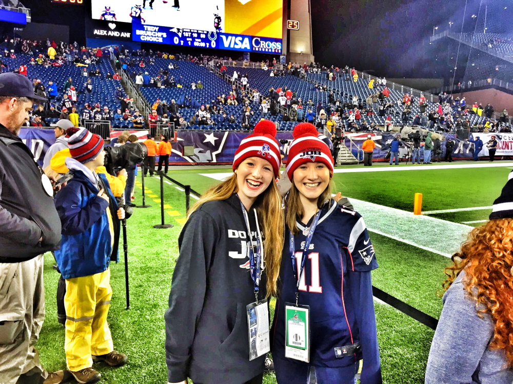 Bethany Hammond, right, and sister Sadie stand on the Gillette Stadium sideline prior to the AFC Championship game Sunday. Bethany, of Belgrade, was a ballgirl for the game.