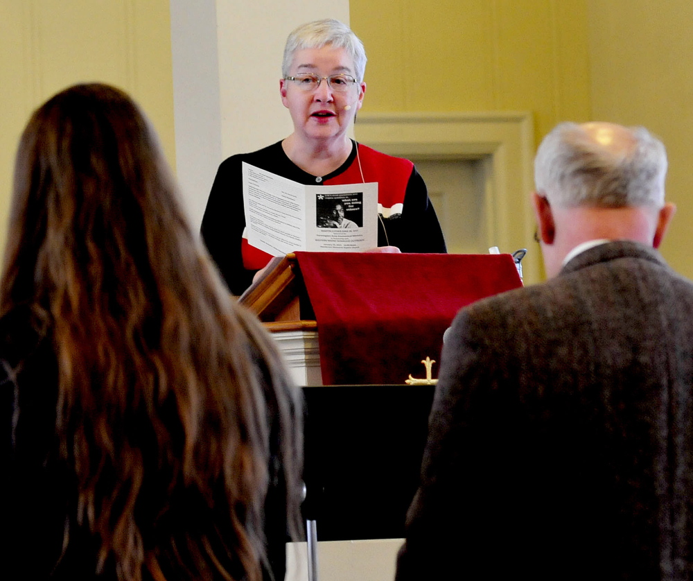 The Rev. Susan Crane speaks with attendees during a Martin Luther King service at Henderson Memorial Baptist Church in Farmington on Monday.