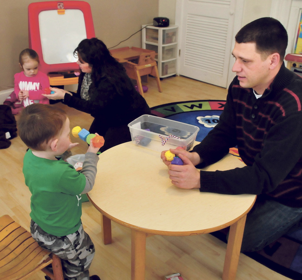 Children’s Center teachers Jacquie Ayo and Elijah Soll work with children at the Skowhegan center on Tuesday.