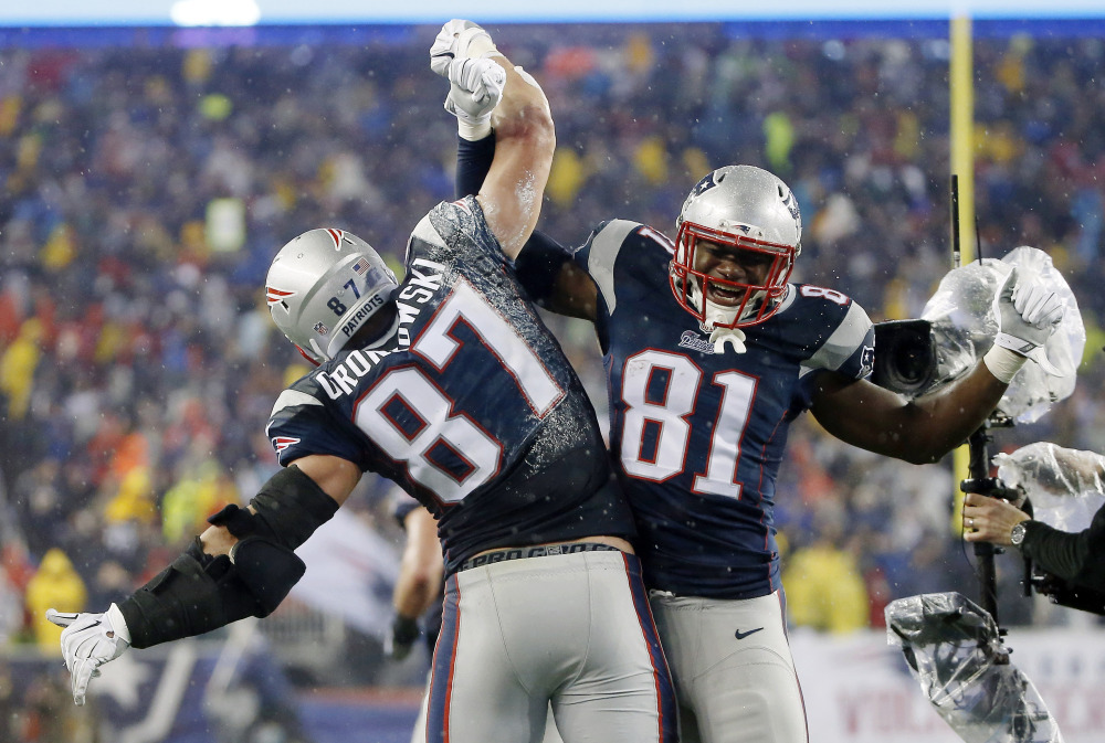 New England Patriots tight end Rob Gronkowski (87) celebrates with teammate Timothy Wright after his five-yard touchdown catch during the second half of the AFC Championship game last week against the Indianapolis Colts in Foxborough, Mass.