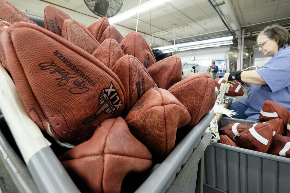 Official game balls for NFL football’s Super Bowl XLIX wait to be laced at the Wilson Sporting Goods Co. in Ada, Ohio on Tuesday. The New England Patriots face the Seattle Seahawks in the Super Bowl on Feb. 1  in Glendale, Ariz.
