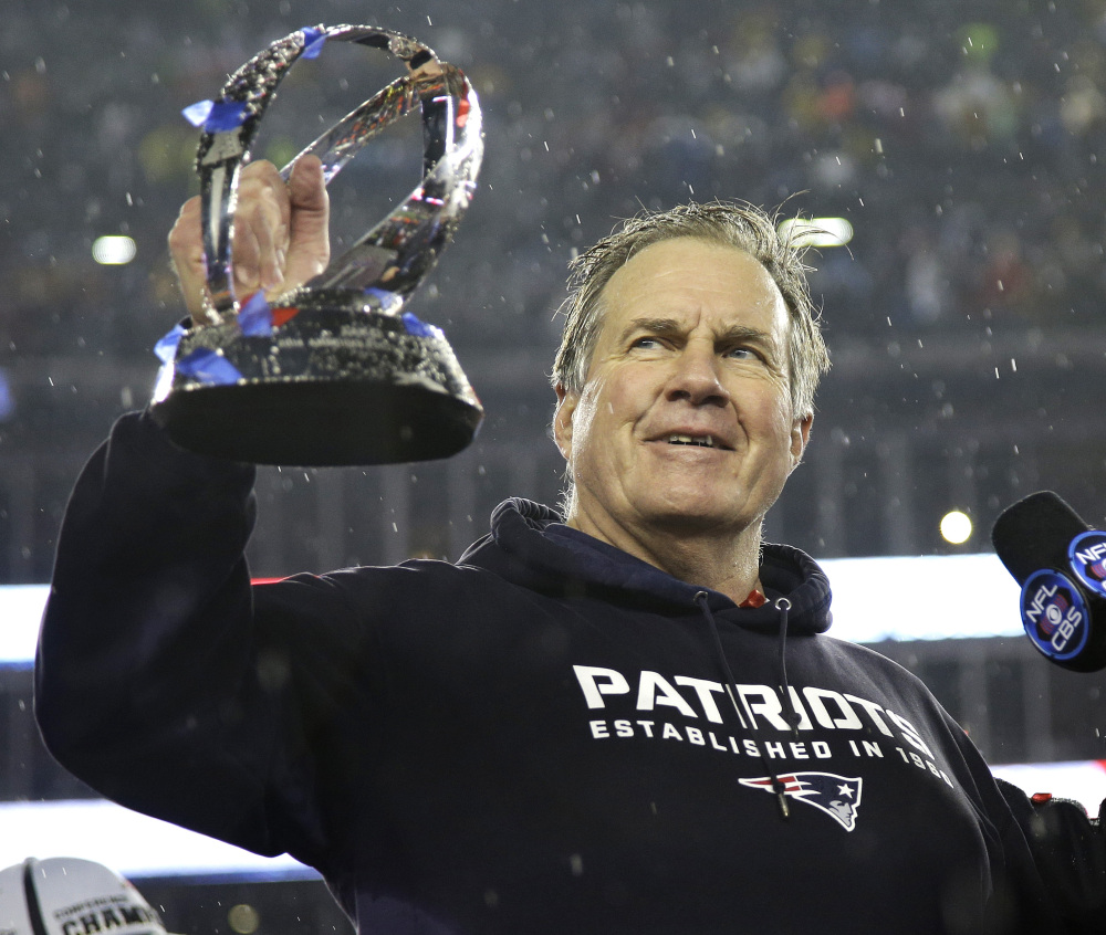 New England Patriots head coach Bill Belichick holds the championship trophy after the AFC Championship game Sunday in Foxborough, Mass. The Patriots defeated the Colts 45-7 to advance to the Super Bowl against the Seattle Seahawks.