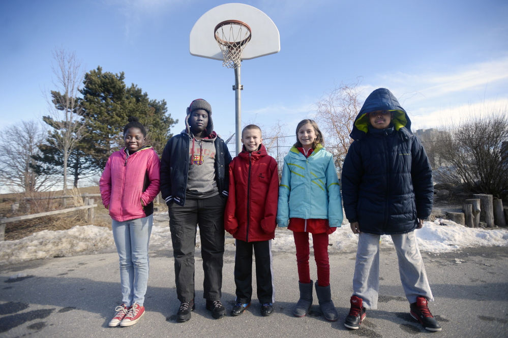 East End Elementary School fifth-graders, from left, Lina Wakati 11, William Lobor, 10, Tyler Hethcoat 11, Shai Knight, 11, and Said Mohamud, 11, weigh the implications of the New England Patriots deflated footballs scandal Wednesday in Portland. When asked about cheating, Lobor said, “Cheaters never win, so what’s the point in cheating?” Knight said, “If I was cheating, I wouldn’t feel like I was actually a winner.”