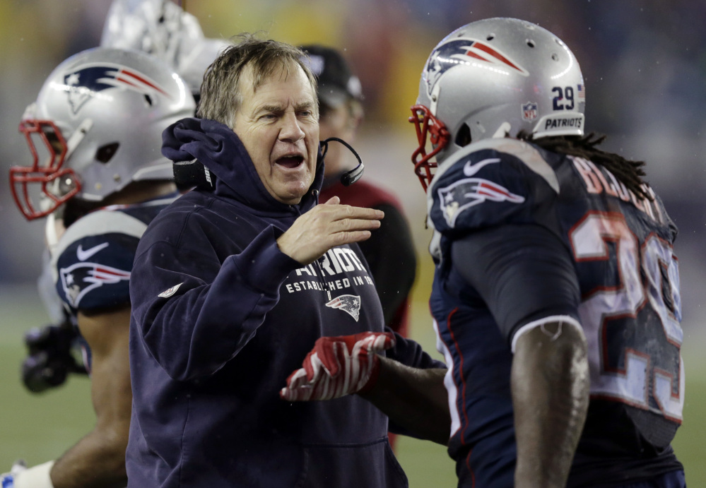 New England Patriots head coach Bill Belichick congratulates LeGarrette Blount after his touchdown during the second half of the AFC Championship game last week in Foxborough, Mass.