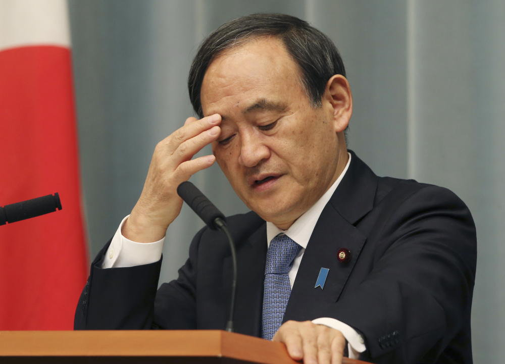 Japan’s Government spokesman Chief Cabinet Secretary Yoshihide Suga ponders during a press conference at the prime minister’s official residence in Tokyo on Friday as militants affiliated with the Islamic State group have posted an online warning that the “countdown has begun” for the group to kill the pair of Japanese hostages.