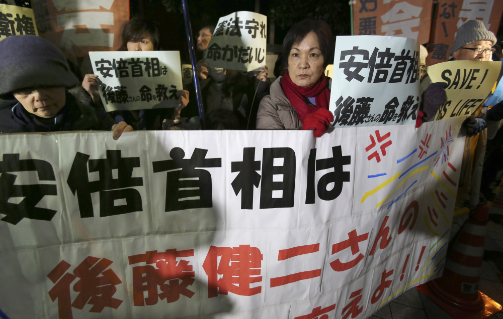 Anti-Prime Minister Shinzo Abe protesters rally with signs and a banner reading: “Prime Minister Abe, save the life of Kenji Goto!” in front of Abe’s official residence in Tokyo Sunday.