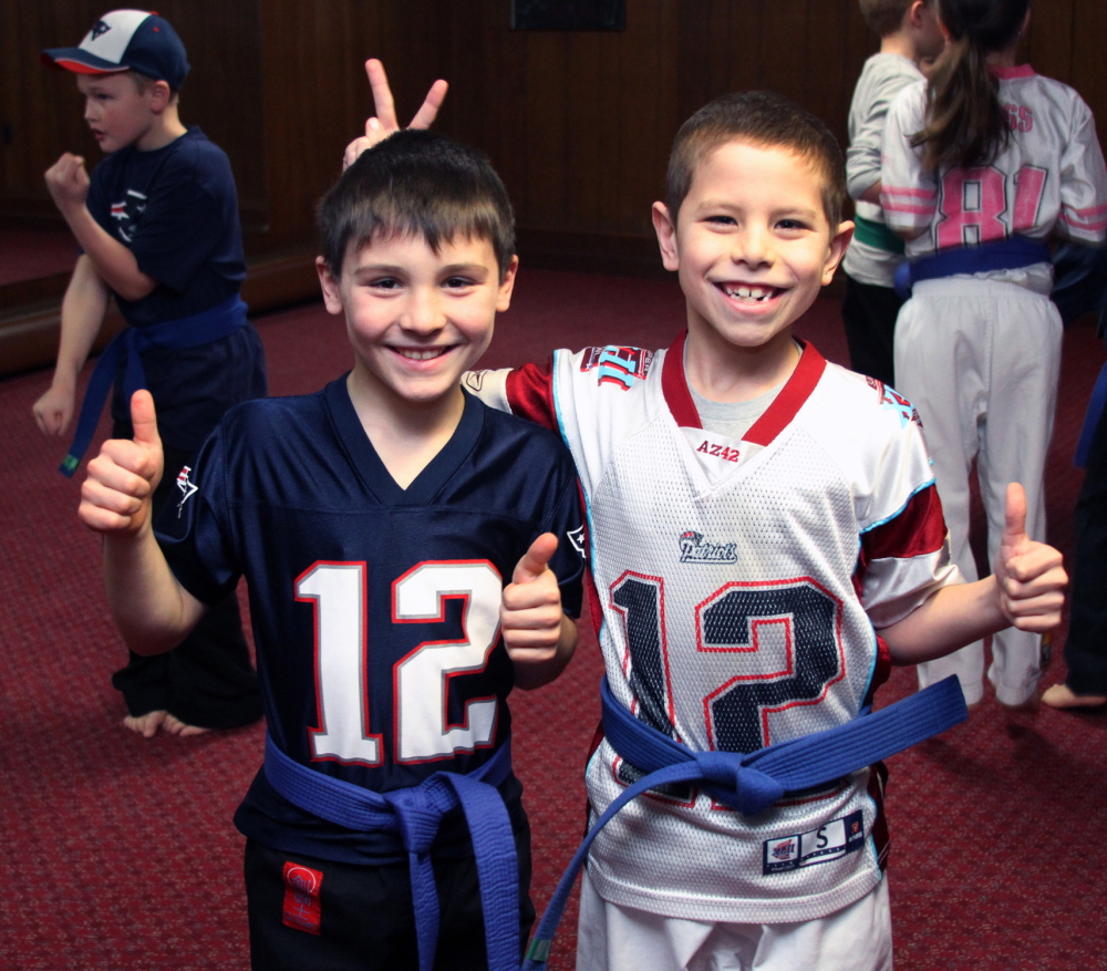 Gaige Martin and Michael Stewart, students at Huard’s Martial Arts Dojo in Winslow, participated Wednesday in a New England Patriots AFC Championships’ rally during class.