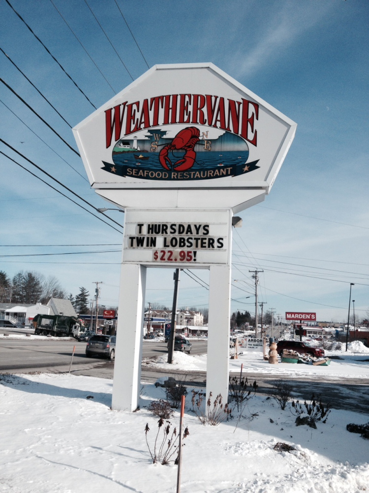 A sign on Kennedy Memorial Drive in Waterville advertises a dinner special at the Weathervane restaurant on Monday. The chain closed restaurants in Waterville, Brewer and South Portland on Monday, citing economic conditions.