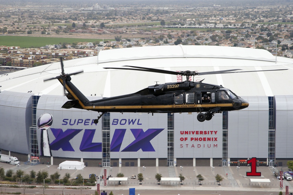 A U.S. Customs and Border Protection Black Hawk helicopter flies above University of Phoenix Stadium, site of Super Bowl XLIX, during a security demonstration Monday in Glendale, Ariz. The helicopters and truck-sized X-ray machines that are typically deployed along the U.S.-Mexico border have been brought to the Super Bowl venue to assist with the security effort.
