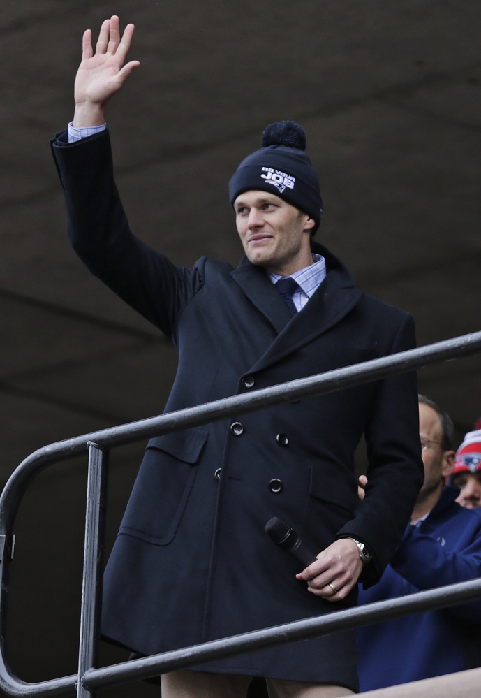 New England Patriots quarterback Tom Brady waves to a crowd of supporters during a sendoff rally at City Hall in Boston on Monday. The Patriots play the Seattle Seahawks in Sunday’s Super Bowl XLIX in Glendale, Ariz.