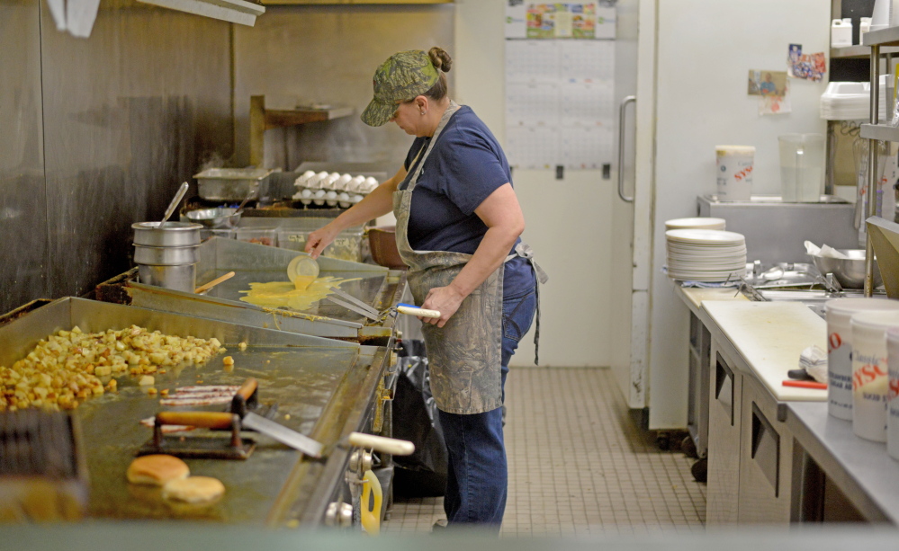 Gracie Furbush prepares food Tuesday in the kitchen at the Early Bird Restaurant in Oakland.