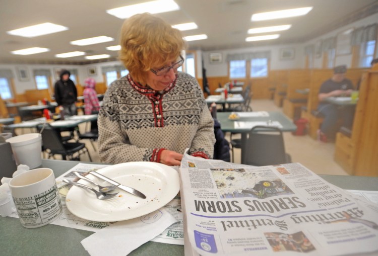 Roberta Drummond, of Oakland, reads a newspaper in January 2015 after eating breakfast at the Early Bird Restaurant in Oakland.