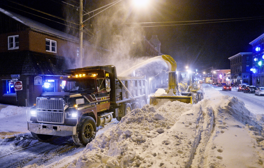 Road crews remove some of Tuesday’s accumulation of snow from Commercial Street with an industrial-strength snowblower and a parade of dump trucks Wednesday as Portland embarked on the process of digging out of this week’s blizzard.