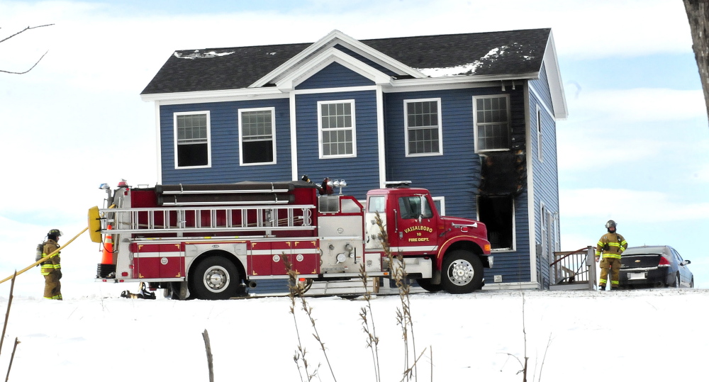 Firefighters from several departments extinguished a fire at a home on Mudget Hill Road in Vassalboro on Wednesday morning. Staff photo by David Leaming