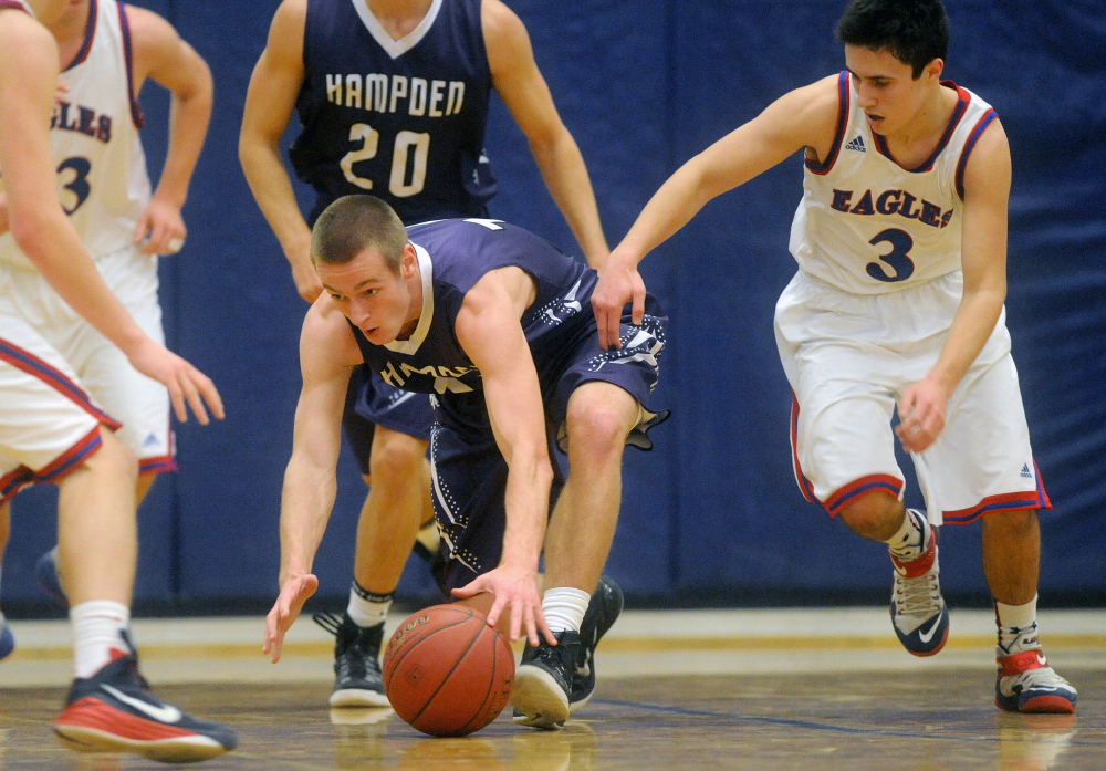 Hampden Academy’s Jake Black, left, battles for the loose ball with Messalonskee High School’s Sawyer Michaud, right, in the first half Wednesday in Oakland.