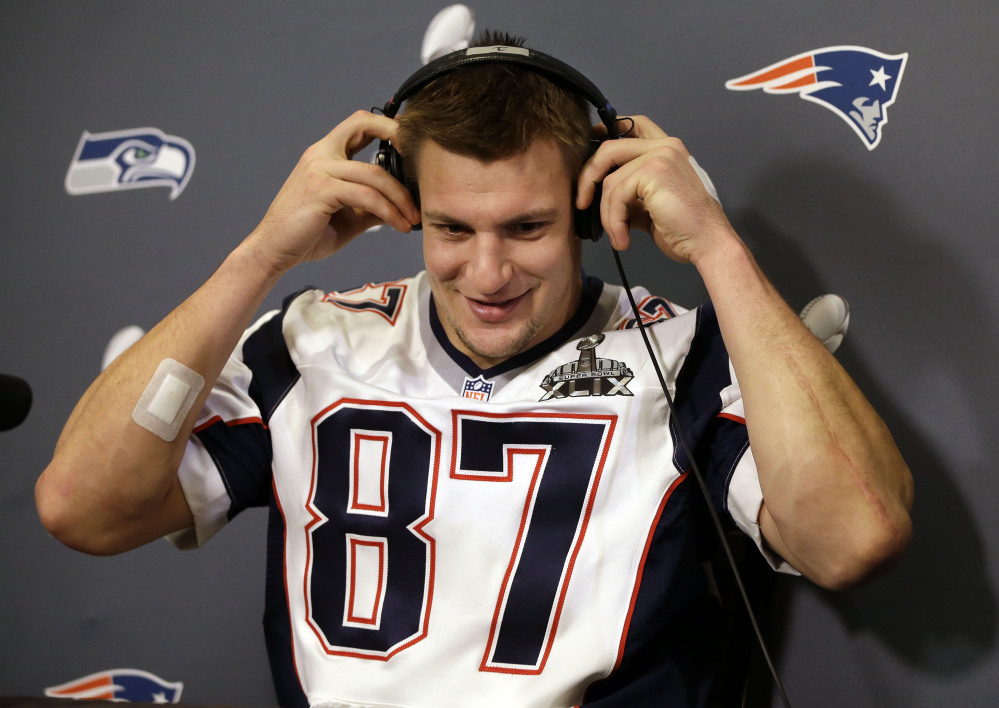 New England Patriots tight end Rob Gronkowski puts on headphones to hear a question during a news conference Thursday in Chandler, Ariz. The Patriots play the Seattle Seahawks in Super Bowl XLIX on Sunday in Phoenix.