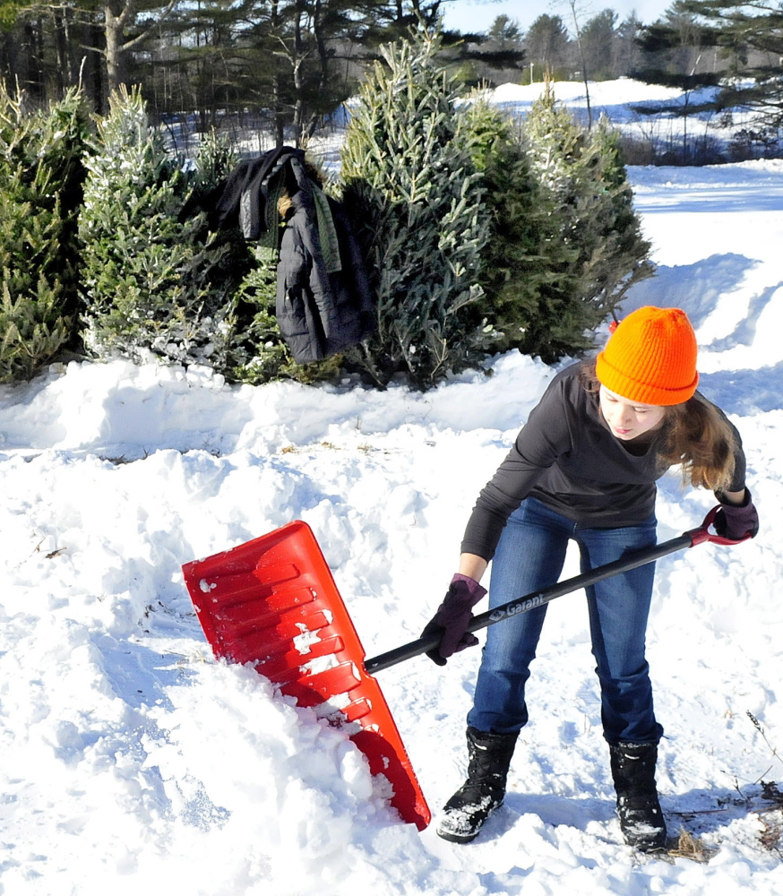 Staff photo by David Leaming
Thomas College student Sydney Sennett digs a path in the snow for the Winter Carnival Christmas tree maze at the Quarry Road Recreation Center in Waterville this Saturday.