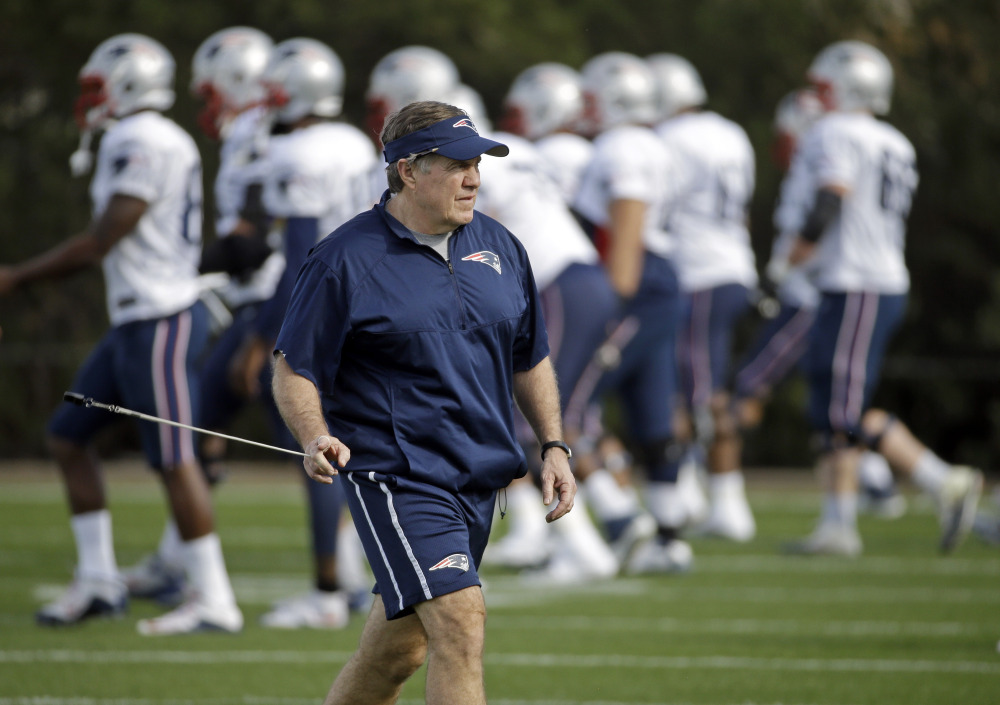 New England Patriots head coach Bill Belichick watches players warm up during practice Wednesday in Tempe, Ariz. The Patriots play the Seattle Seahawks in Super Bowl XLIX on Sunday in Glendale, Ariz.