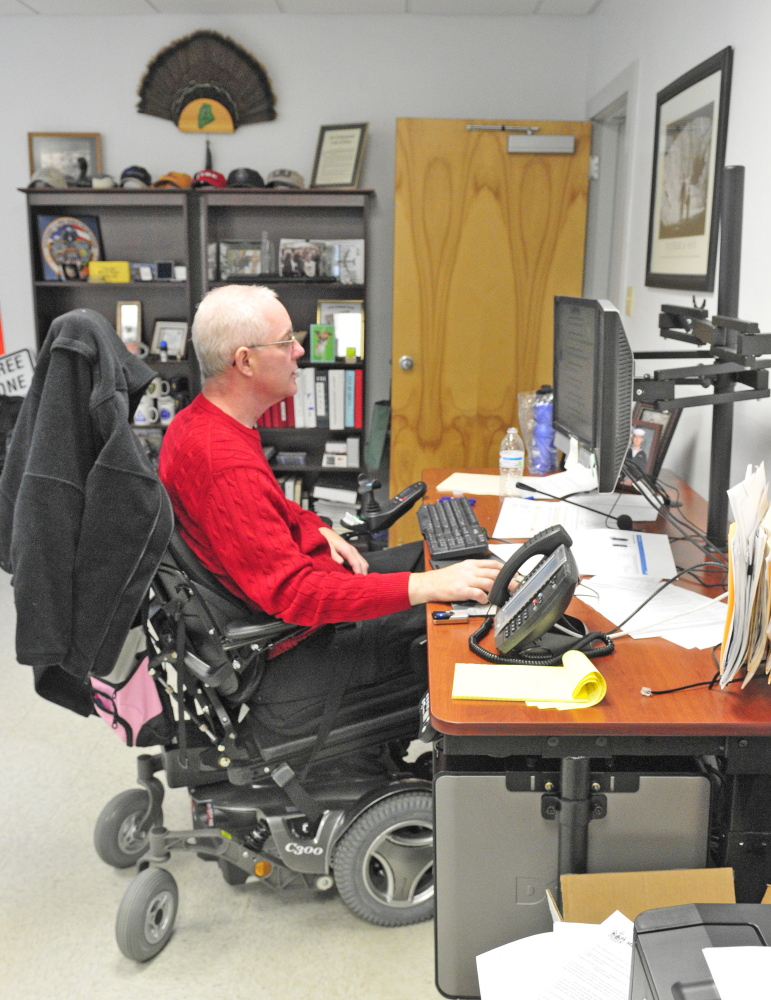 Staff photo by Joe Phelan
Augusta Police Chief Robert Gregoire used to lose his balance easily in his motorized chair if forced to lean forward, but now he can hold himself steady.