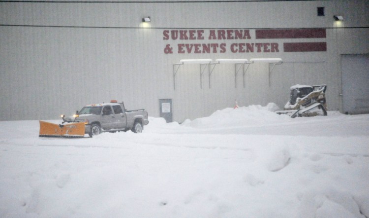 Staff photo by Michael G. Seamans 
 A plow truck clears the empty parking lot at Sukee Arena in Winslow on Friday.