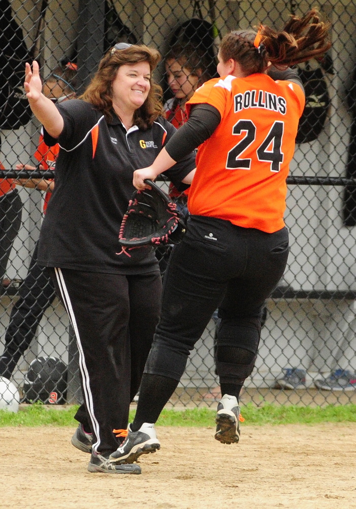 Staff file photo by Joe PhelanGardiner pitcher Brittany Rollins, right, leaps into arms of coach Ginger Shaw after a 4-1 victory over Presque Isle in June. Shaw won’t return to the Tigers dugout this spring.