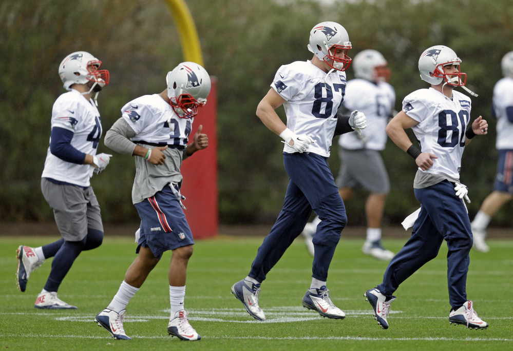 New England Patriots running back Shane Vereen (34), tight end Rob Gronkowski (87) and wide receiver Danny Amendola (80) warm up during practice Friday in Tempe, Ariz. The Patriots play the Seattle Seahawks in Super Bowl XLIX on Sunday.