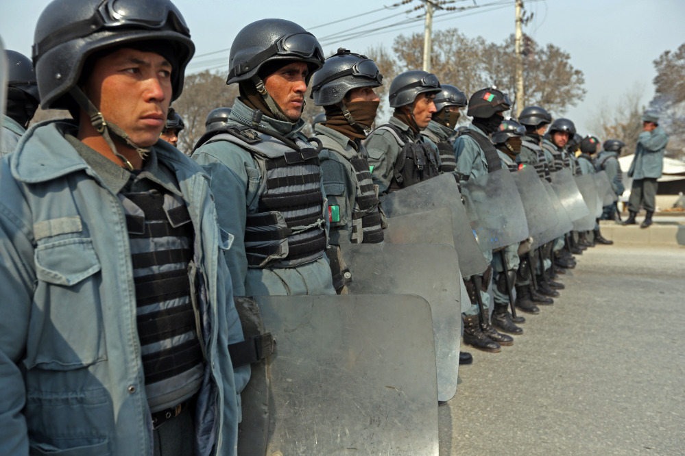 Afghan policemen block a road during a protest against caricatures of the Prophet Muhammad published in the French magazine Charlie Hebdo, in Kabul, Afghanistan, on Saturday.