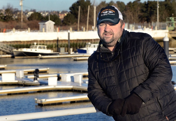 Capt. Mike Faulkingham is a charter boat captain, seen at his home port at Spring Point Marina in South Portland. He said, "There isn’t a guide here who’s not thrilled" about a mandate to reduce the number of striped bass that can be caught by recreational fishermen.  Photo by John Patriquin/Staff Photographer