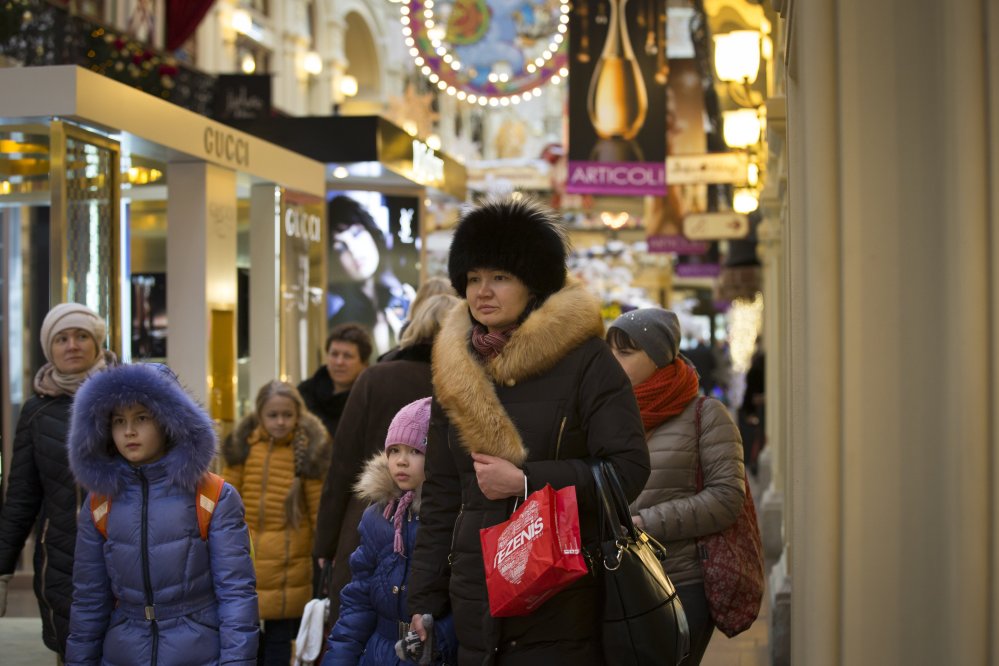 Only the well-heeled can afford to shop at the GUM department store in Moscow. “Here, everything changes so often. So I would like stability,” shopper Olga Mozalyova said. New Year’s Day began a long holiday for most Russians that runs until Jan. 12.  The Associated Press