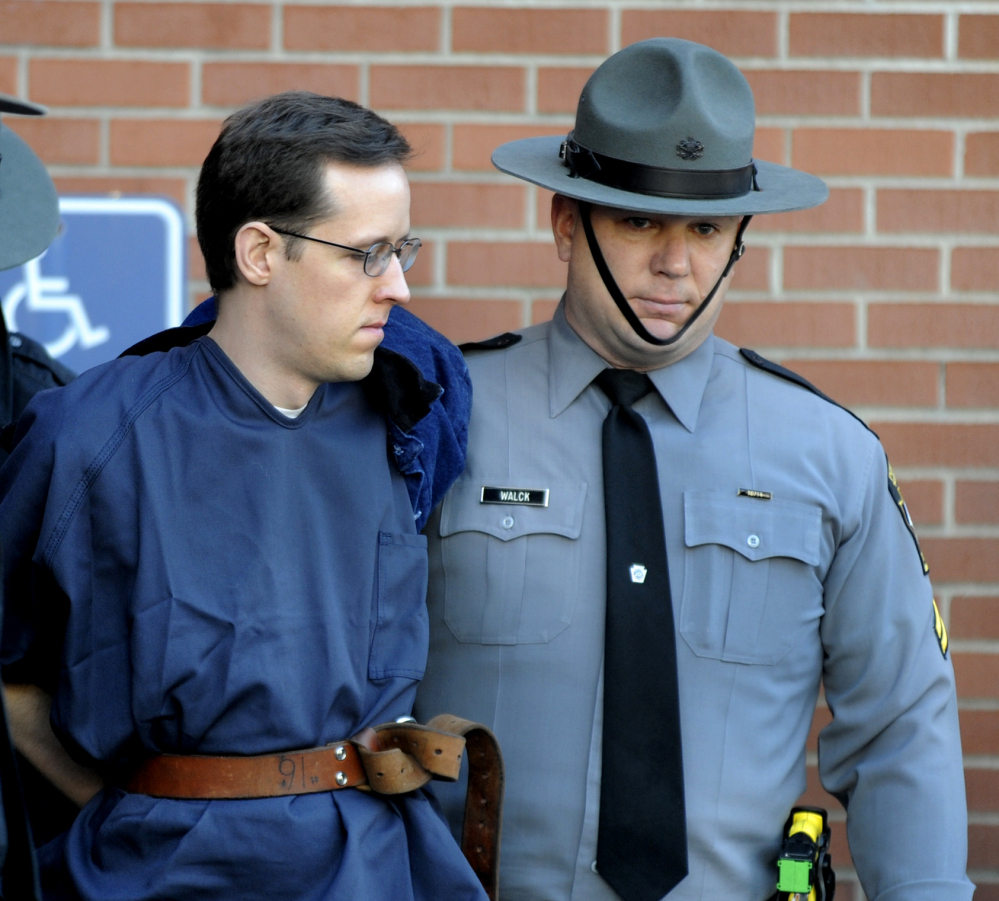 Eric Frein is led from the courthouse after his hearing Monday in Milford, Pa. Frein is charged with fatally shooting one state trooper and wounding another. The Associated Press