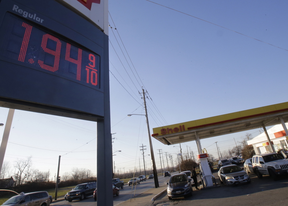 A gas station in Cleveland advertises a price of $1.94 per gallon. The price of oil plunged Monday and dipped below $50 a barrel for the first time in more than five years. The Associated Press