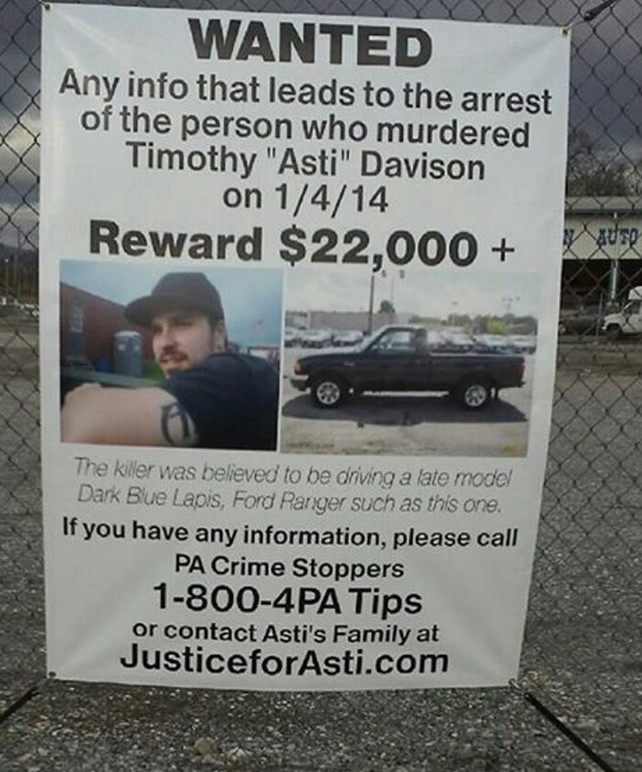 In this Jan. 6, 2015, photo,  a sign posted on a fence in Pennsylvania helps to keep the death of Timothy ‘Asti’ Davison in the public eye.