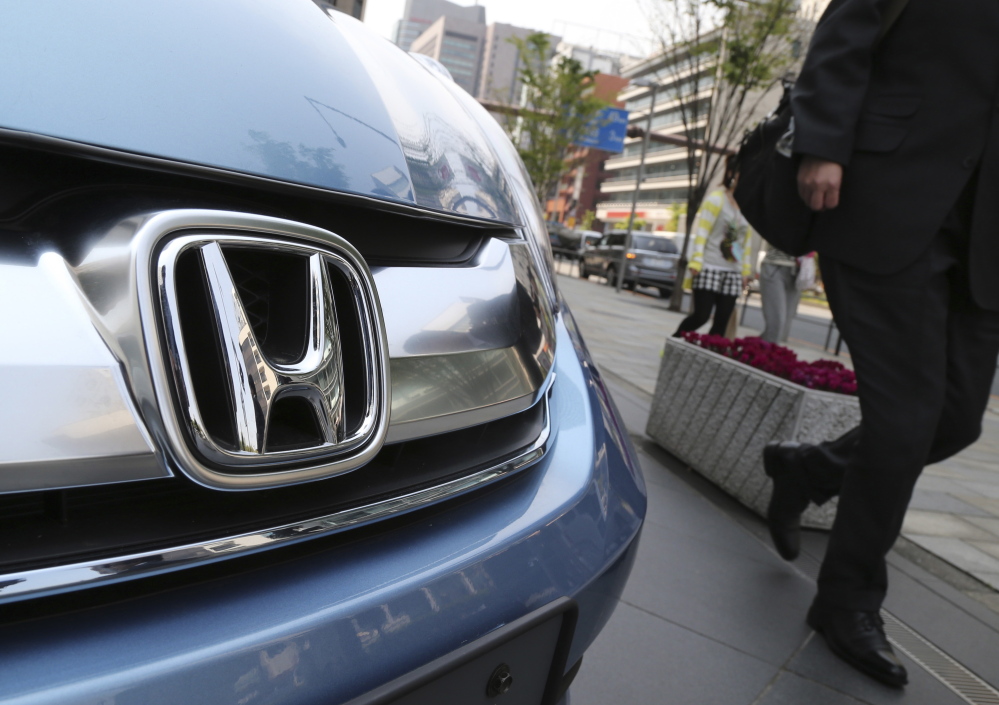 Honda Motor Co. displays a vehicle at its headquarters in Tokyo. U.S. officials say the automaker has agreed to pay a $70 million fine for failure to report violations.  The Associated Press