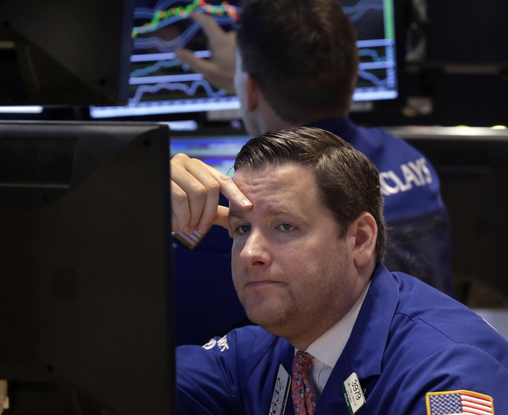 Trader Gregg Maloney works on the floor of the New York Stock Exchange. There was little good news Monday as U.S. crude oil hit $46.07 a barrel, which put a drag on stocks. The Associated Press