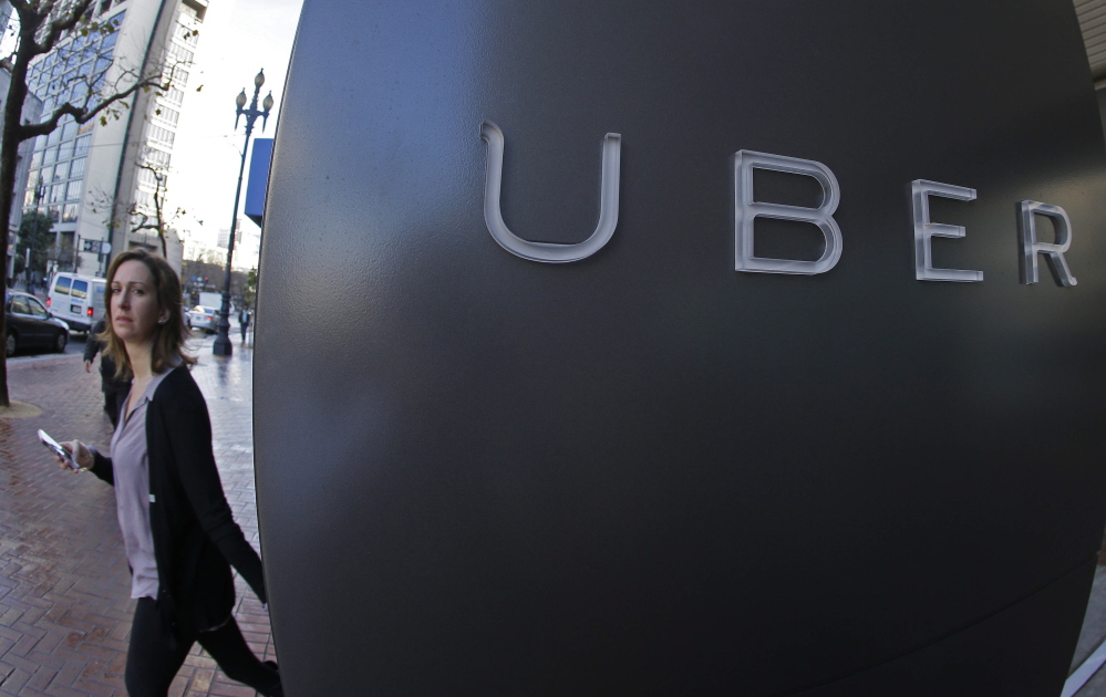 A woman leaves Uber headquarters in San Francisco. The company will now share data on travel patterns.