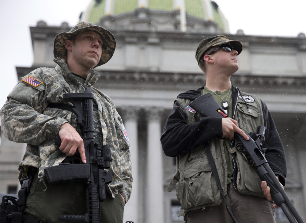 Gun rights advocates demonstrate at the State Capitol in Harrisburg, Pa., on Tuesday during the Second Amendment Action Day. A new state law is taking aim at municipal regulations on guns. The Associated Press
