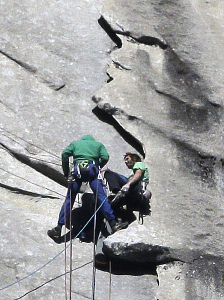 Tommy Caldwell, left, and Kevin Jorgeson approach the summit of El Capitan on Wednesday. The men started “free-climbing” to the 3,000-foot summit on Dec. 27, using no climbing aids other than ropes to prevent falls. The Associated Press