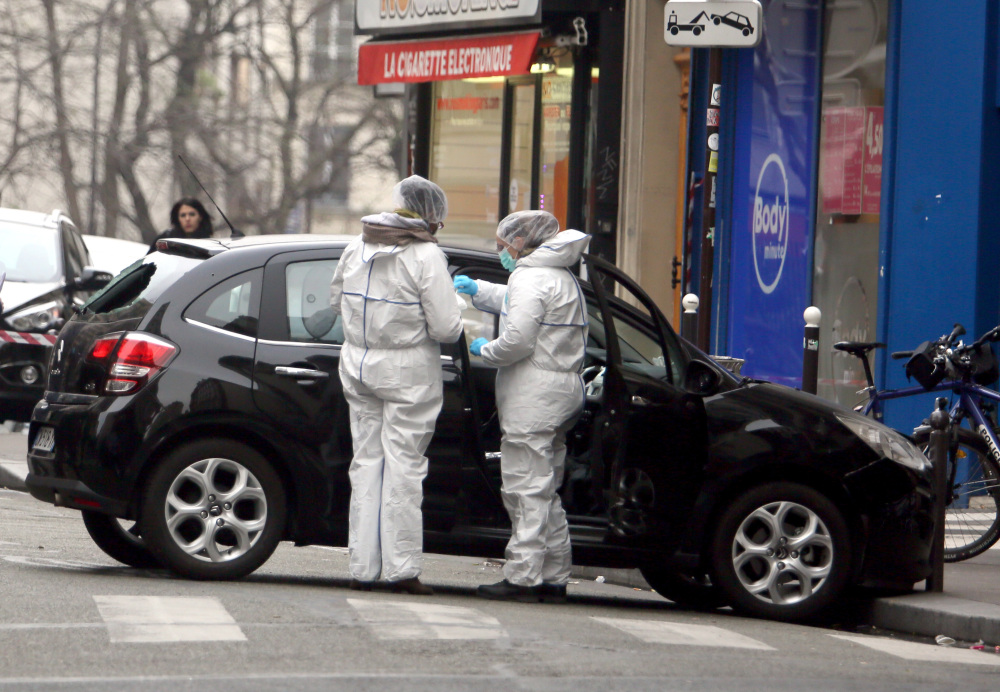 Forensic experts examine the car believed to have been used by the gunmen who attacked Charlie Hebdo’s office in Paris on Jan. 7. A week after the terror attacks, investigators are still unraveling the complex, overlapping contacts among the gunmen and their suspected accomplices.
Jan. 7, 2015, File Photo / The Associated Press