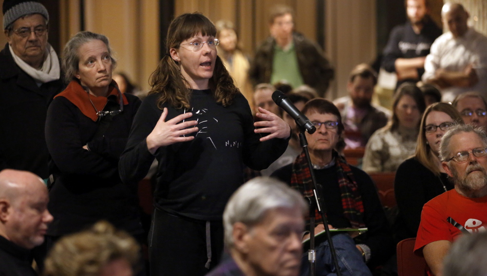 Monica Bowen, of Boston, asks a question during a public meeting Wednesday to mobilize efforts to keep the 2024 Summer Olympic Games from coming to the city.  The Associated Press