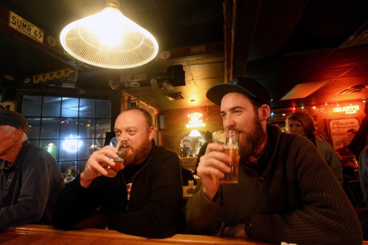 Chad Hutchins, left, and Alexander Jones of South Portland drink Foundation Epiphany IPA at the Great Lost Bear in Portland during the Industrial Park Challenge on Thursday. Photo by Shawn Patrick Ouellette/Staff Photographer