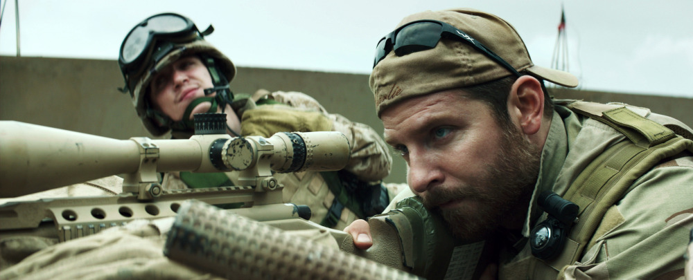 Bradley Cooper, right, appears in a scene from “American Sniper.” The movie has drawn criticism from some as military propaganda and then fierce defense from others who say veterans are underappreciated. The Associated Press
