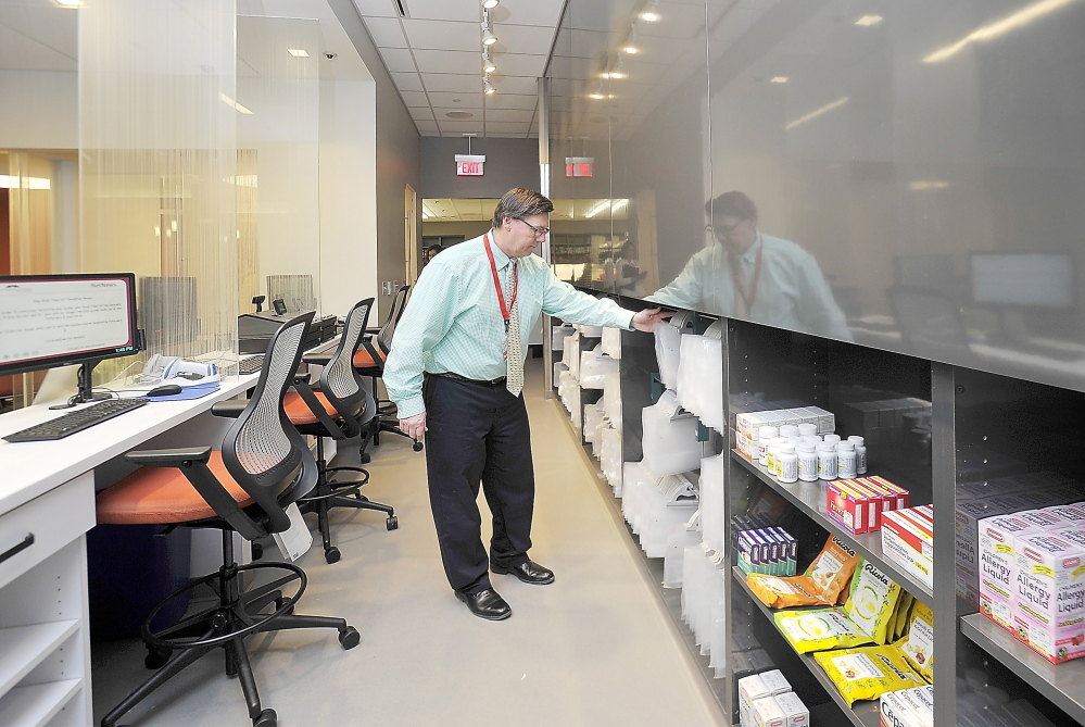William Hewitt organizes the front end of the state’s first 24-hour pharmacy at Maine Medical Center before Monday’s official opening. Gordon Chibroski/Staff Photographer
