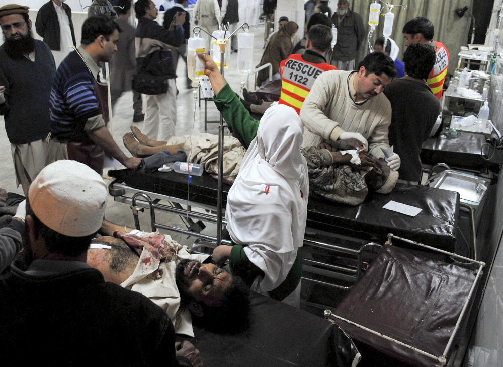 Wounded victims of a suicide bombing are treated at a hospital in Peshawar, Pakistan, in 2010 after a female suicide bomber detonated an explosives-laden vest in a crowded aid distribution center. Terrorist groups have been recruiting women for years, but authorities underestimate them, counterterrorism experts say. The Associated Press