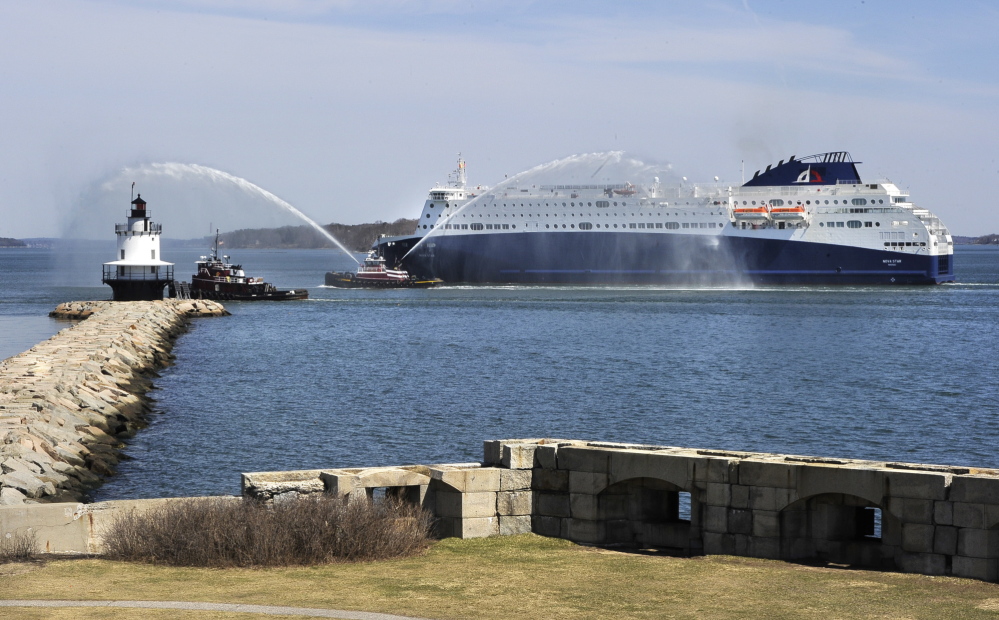 The Nova Scotia government will announce its plans next week for the future of the Nova Star ferry, shown here in Portland harbor passing Spring Point Light in South Portland while a tugboat sprays a welcome.  2014 Press Herald File Photo/John Patriquin