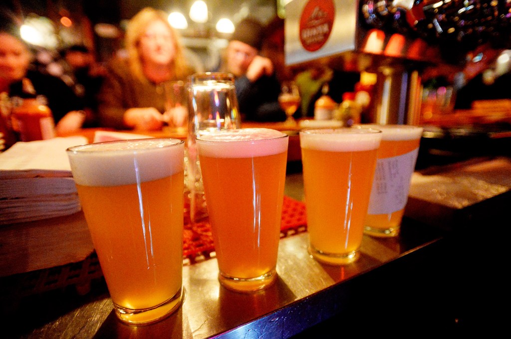 Pints of Austin Street Patina Pale Ale are lined up at the bar during the Industrial Park Challenge on Thursday at the Great Lost Bear in Portland. The beer finished second in the popularity contest. Photo by Shawn Patrick Ouellette/Staff Photographer