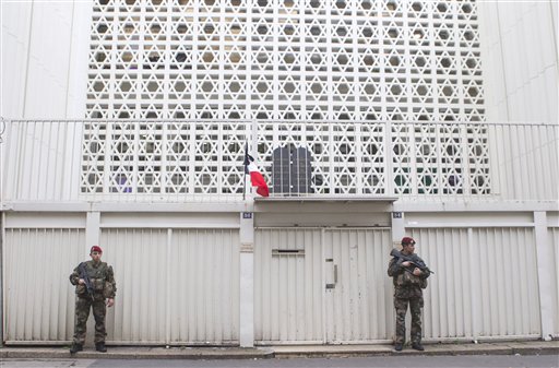 Soldiers stand guard outside a synagogue in Paris. France on Monday ordered 10,000 troops into the streets to protect sensitive sites. The Associated Press