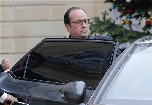 French President Francois Hollande leaves the Elysee Palace after the shooting at a French satirical newspaper in Paris Wednesday. Police say 11 people were killed in the shooting. The Associated Press